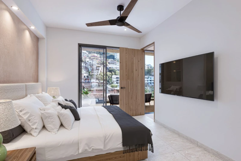 Guest bedroom with balcony access and wall-mounted television